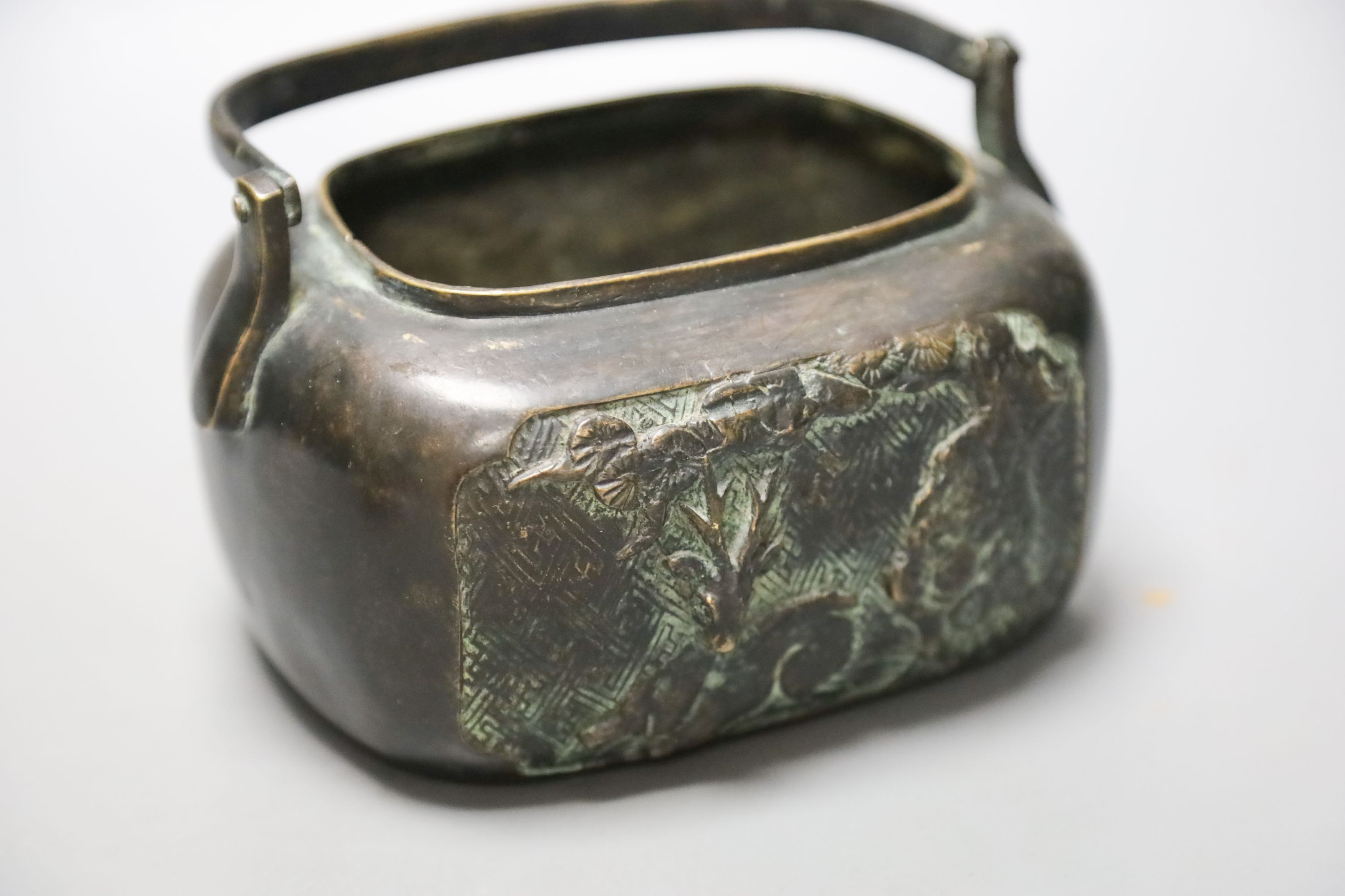 A Chinese bronze hand warmer, Xuande mark to base, old repairs 15cm